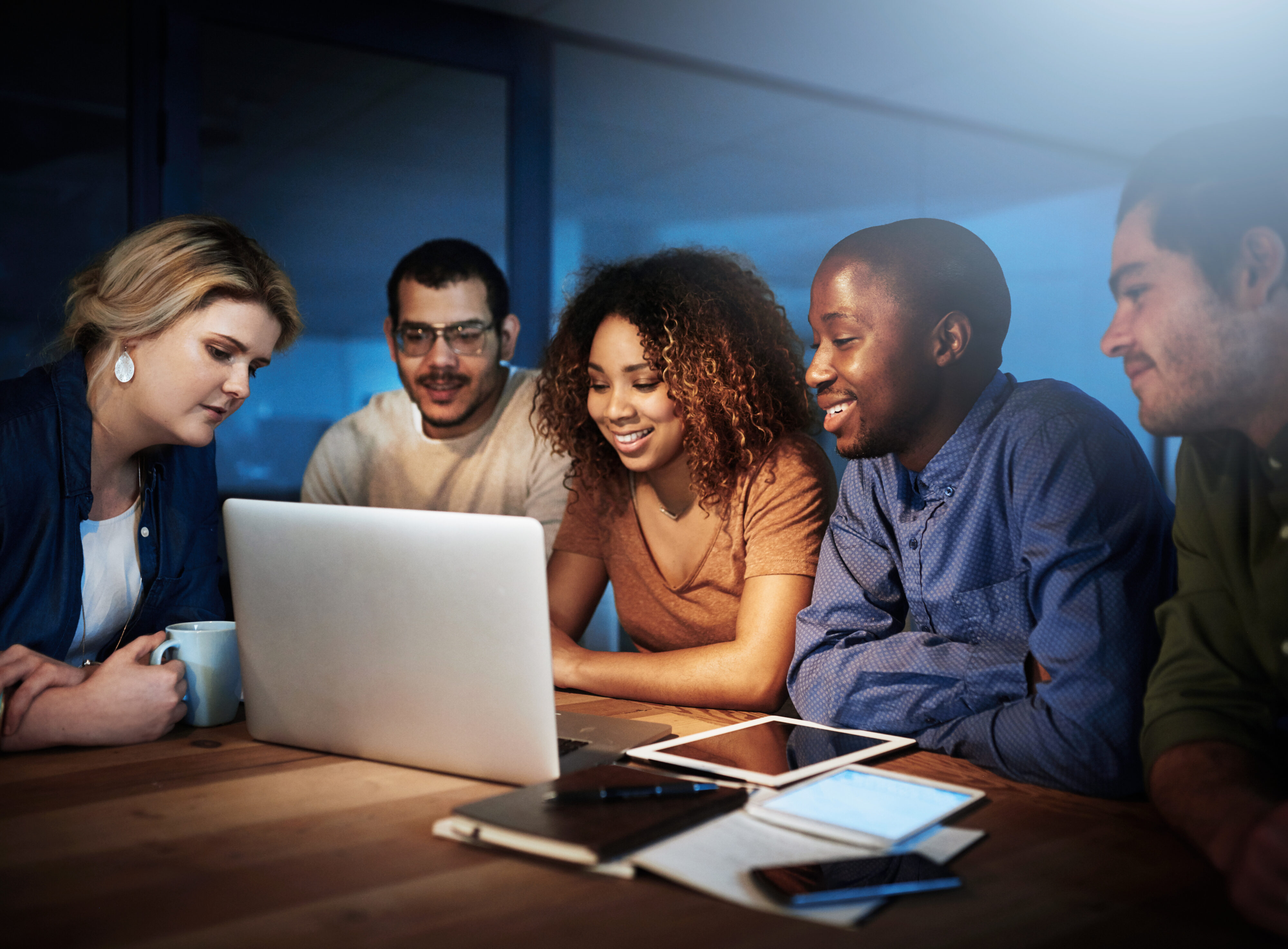 The hours are long, but itll be worth it. a team of young businesspeople working late in the office